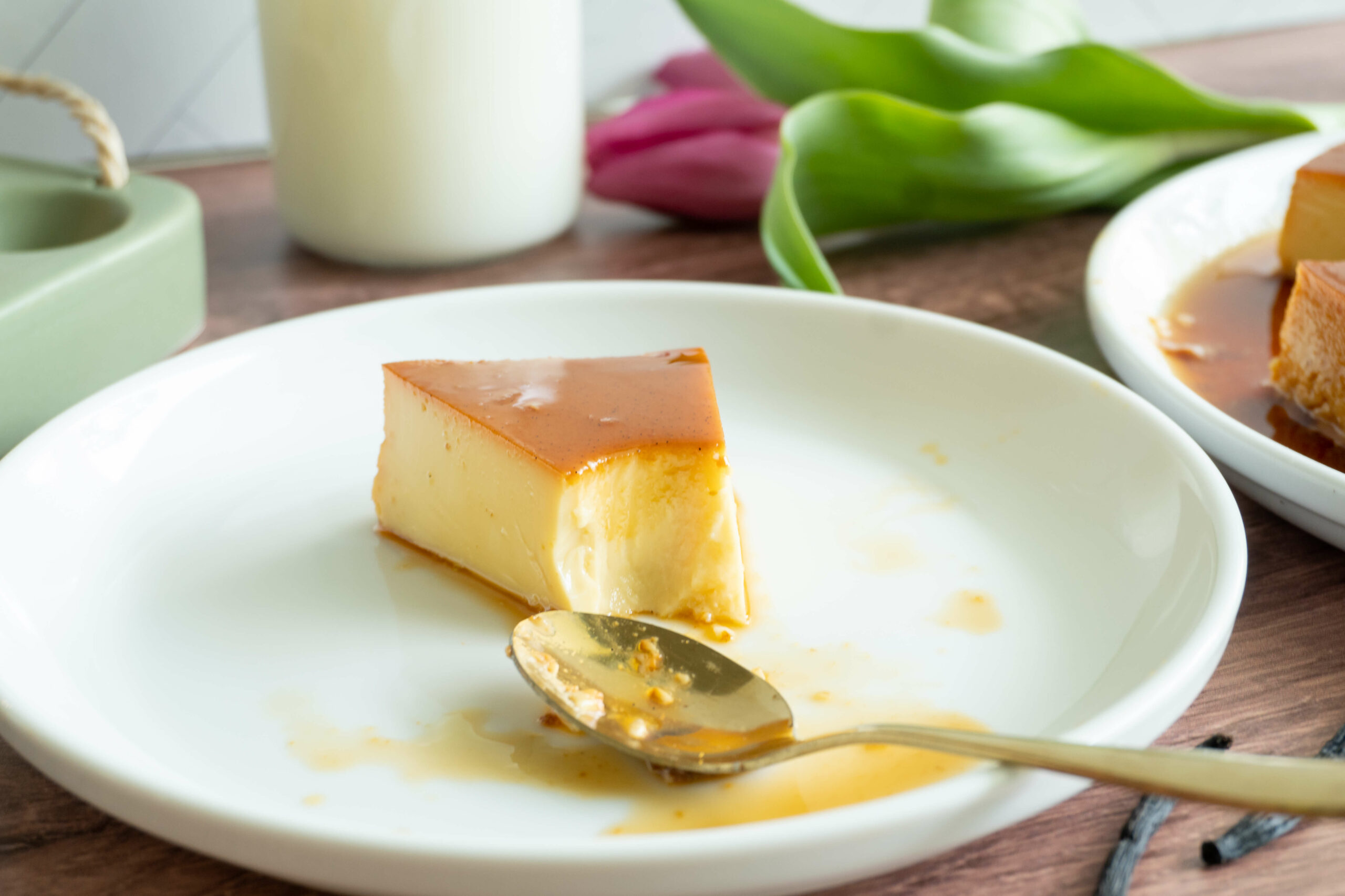 close up of flan slice with a spoon shoeing the texture