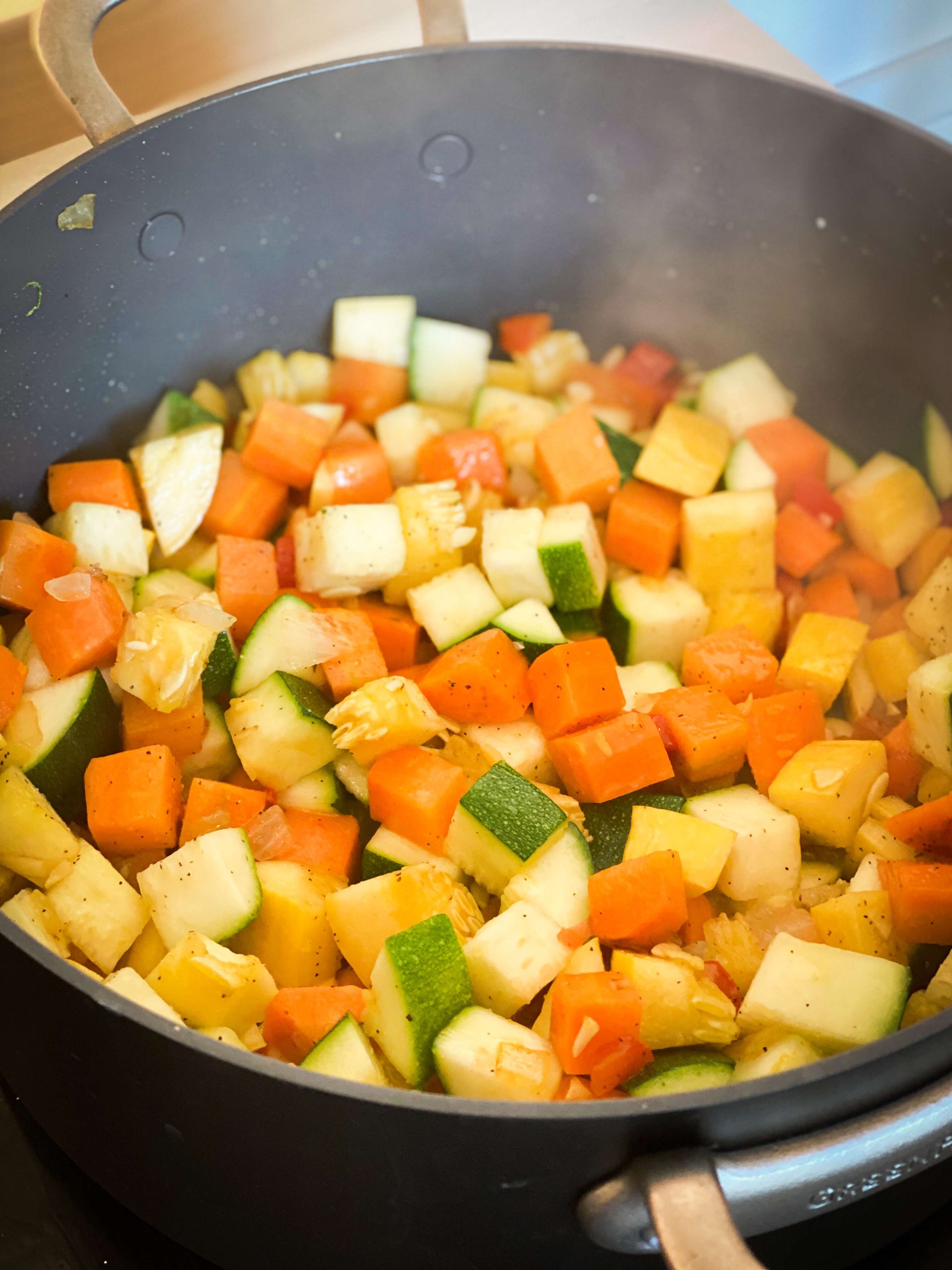Onions and peppers sautéing in olive oil