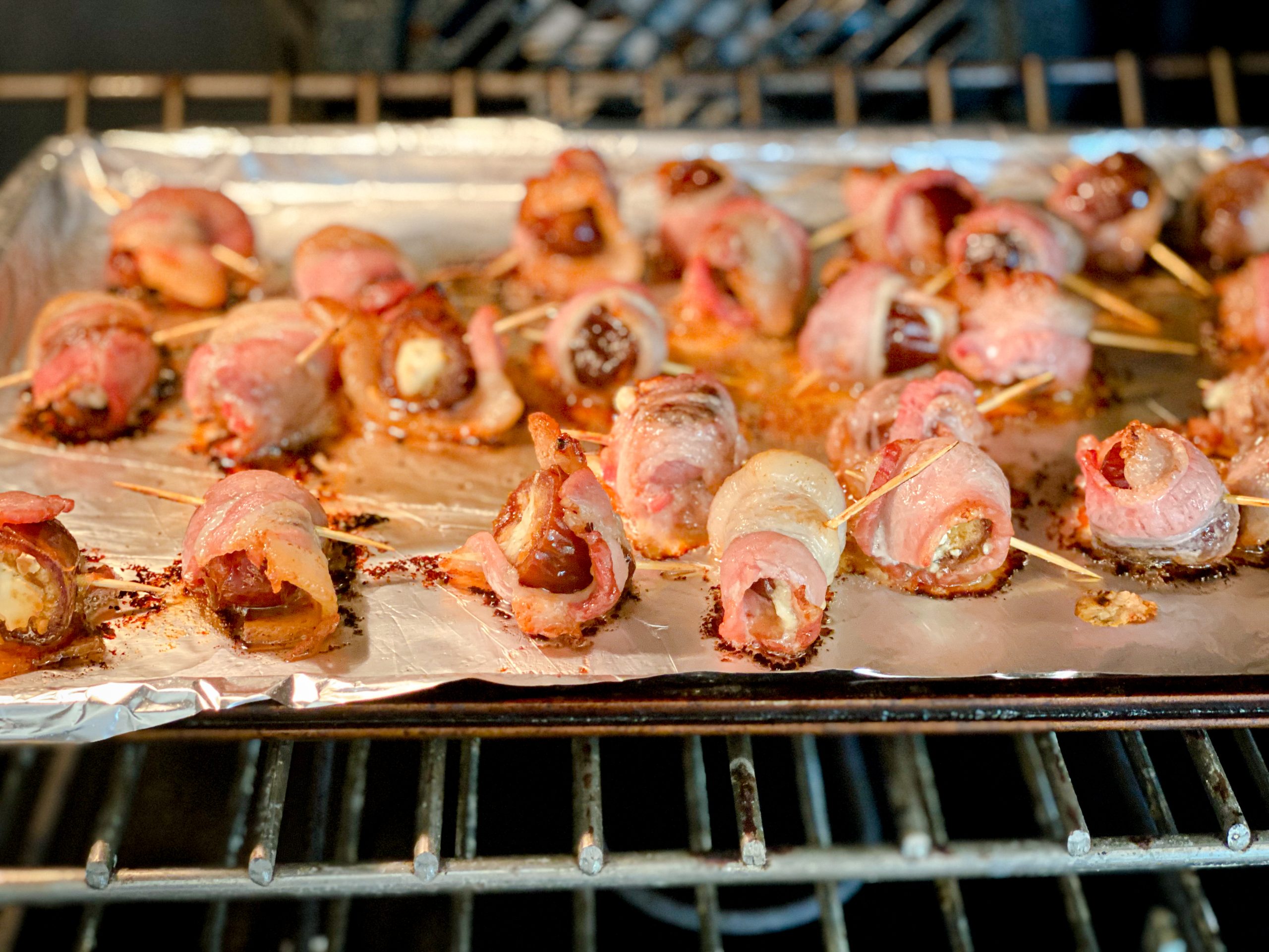 Halfway into the cooking process bacon wrapped dates