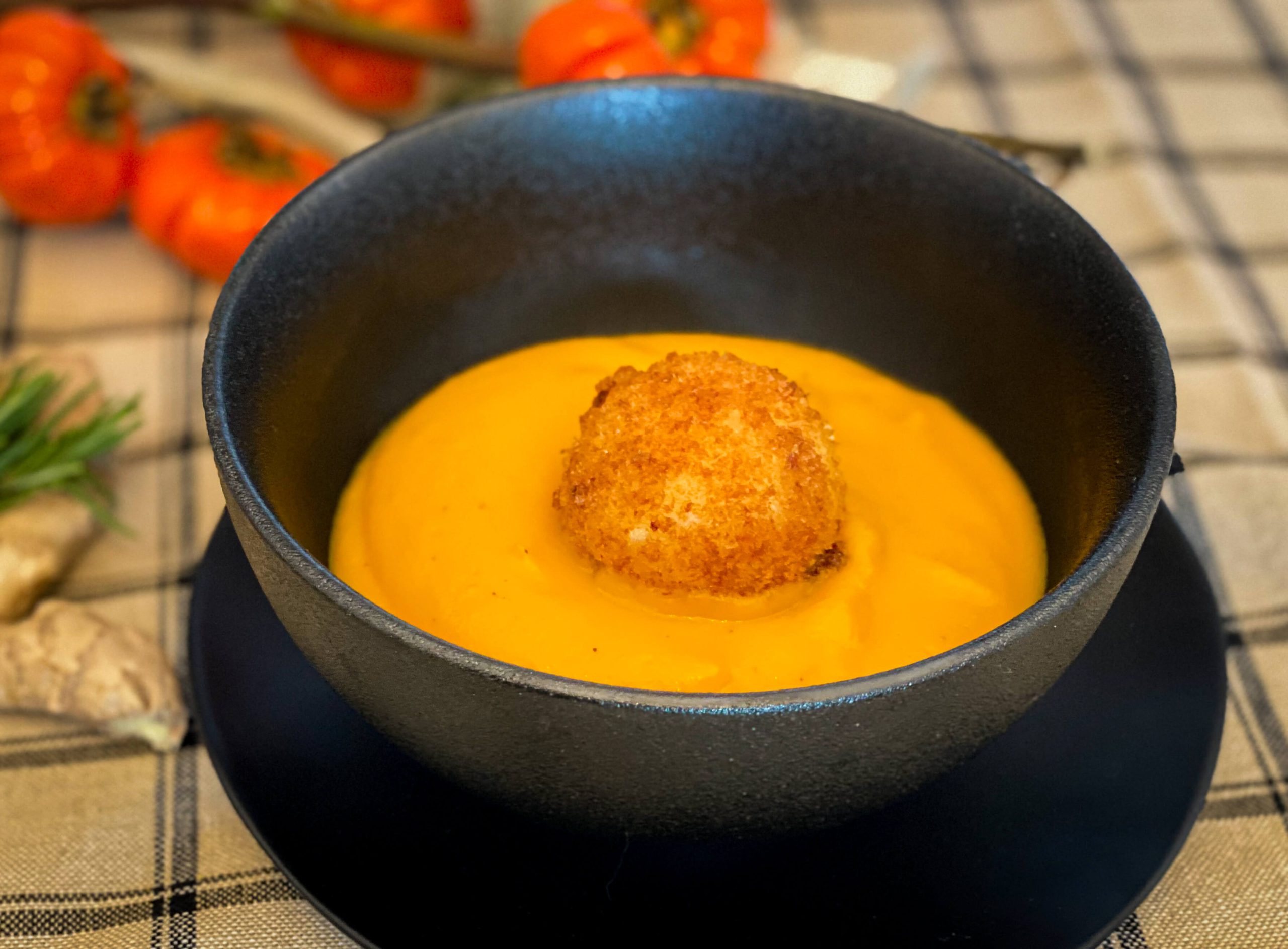Roasted butternut squash soup with goat cheese nugget served