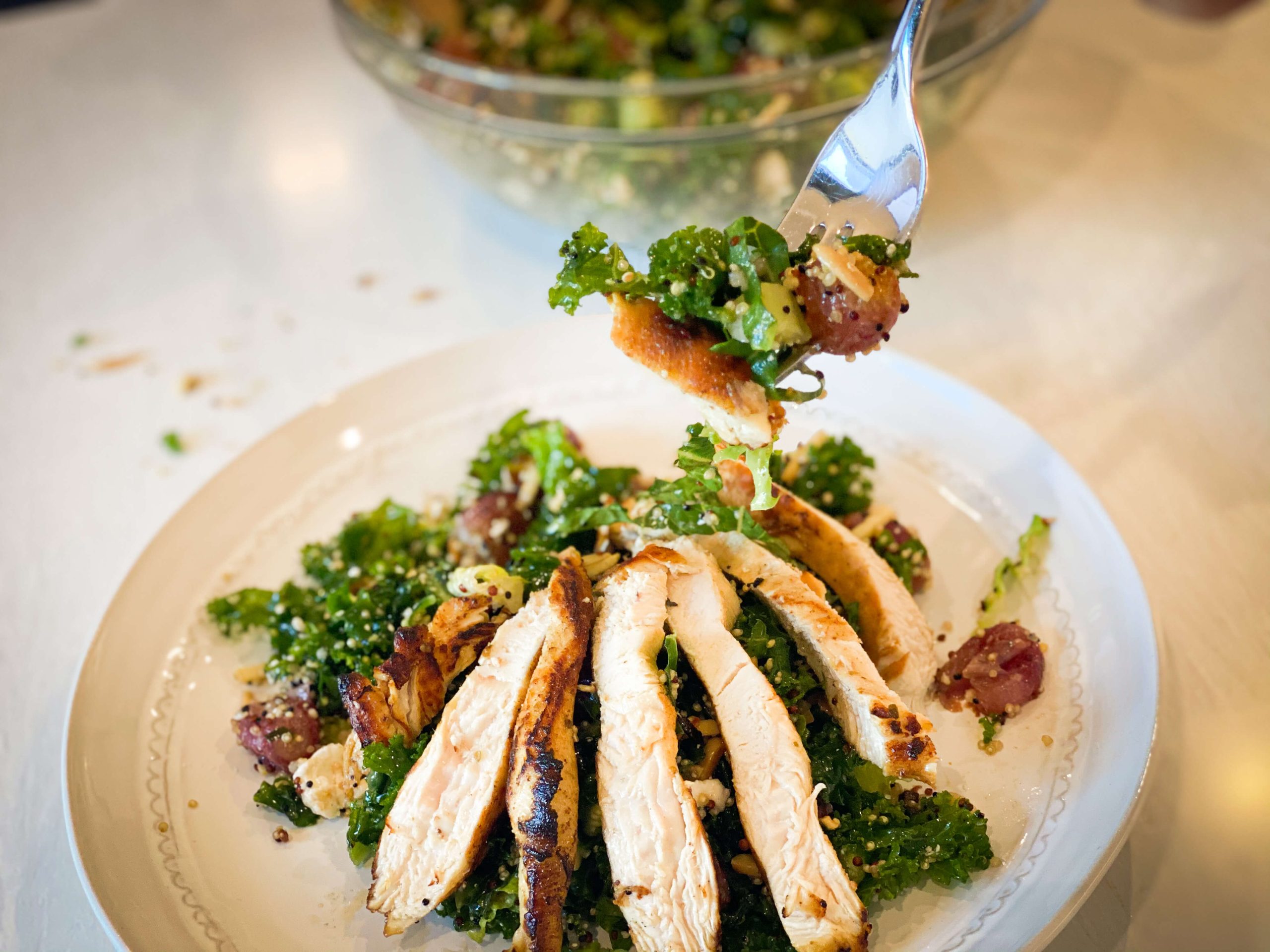 Kale quinoa salad with roasted-grapes being served