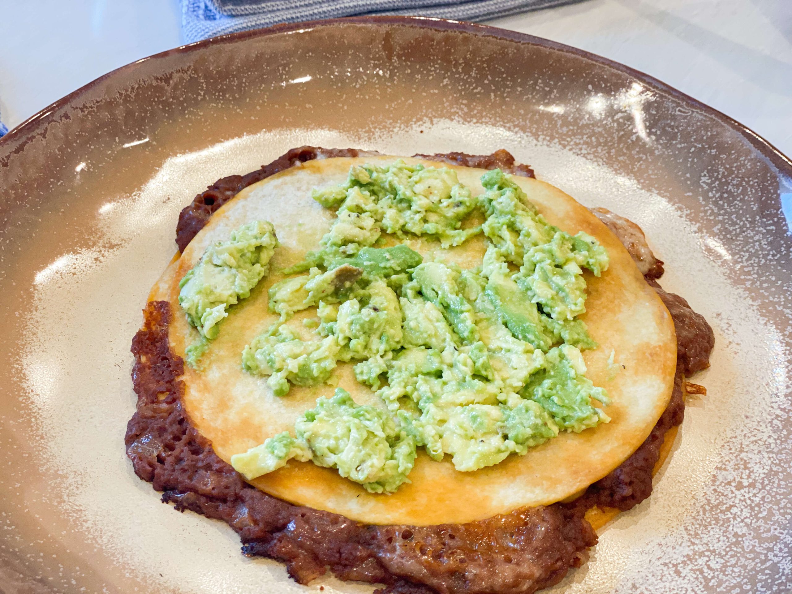 avocado smashed on top of the quesadilla 
