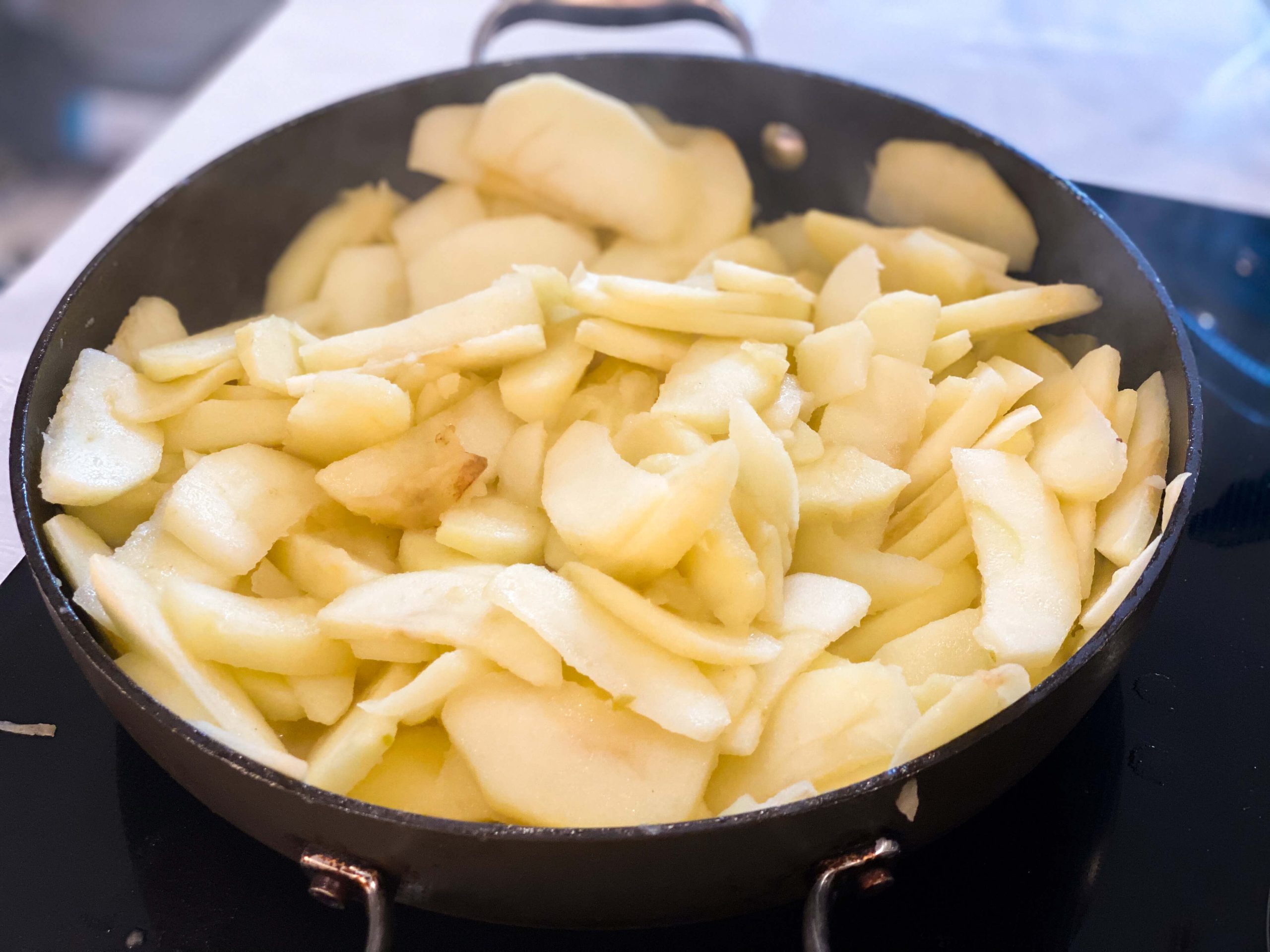 apples sautéing in pan with melted butter