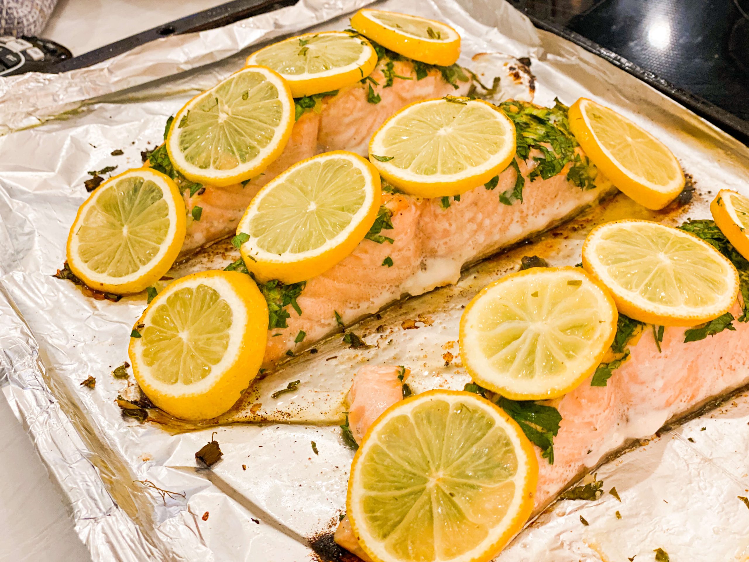 cooked salmon with herbs, mustard and lemon slices