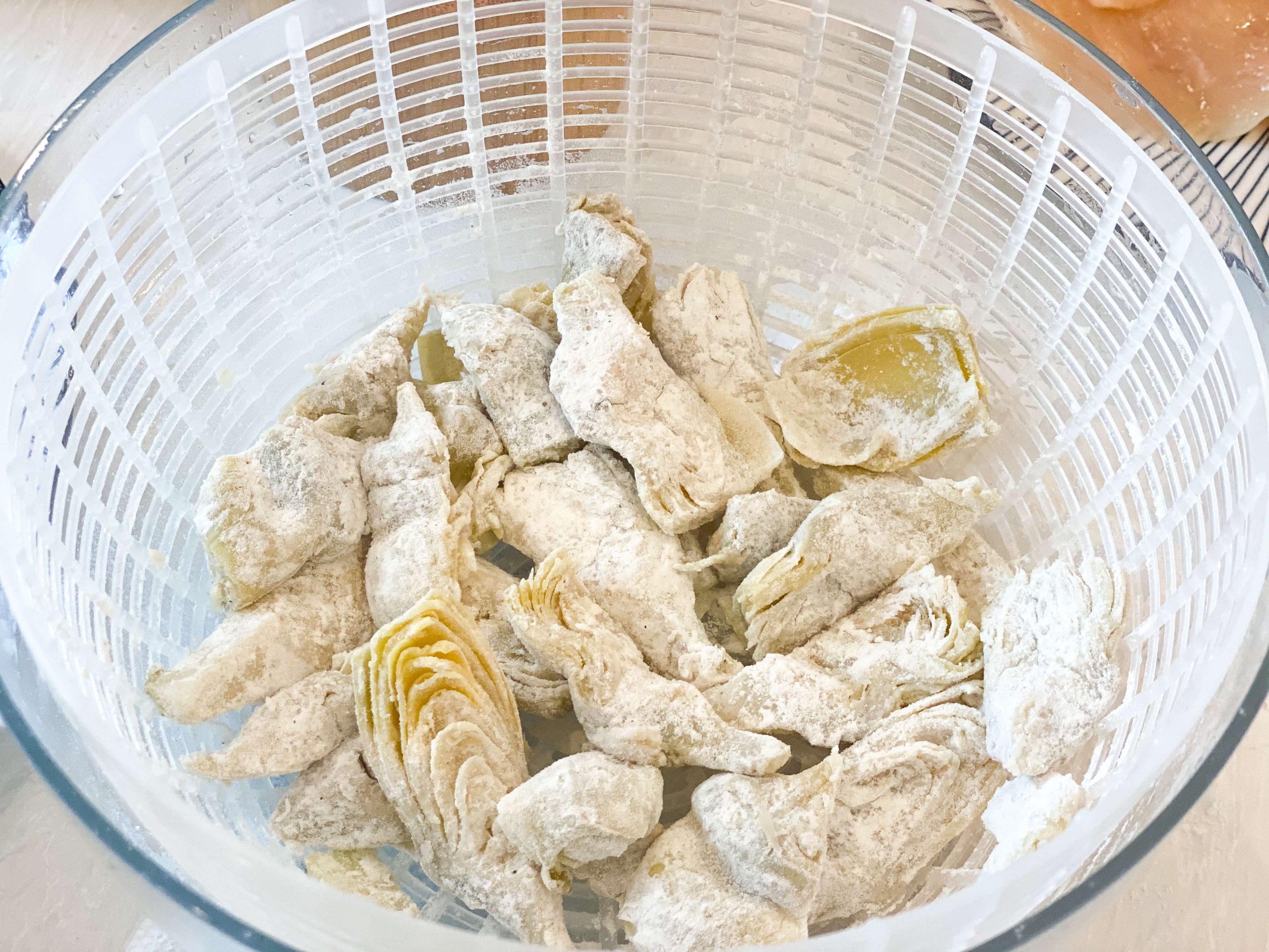 artichokes in the salad spinner to remove excess flour 