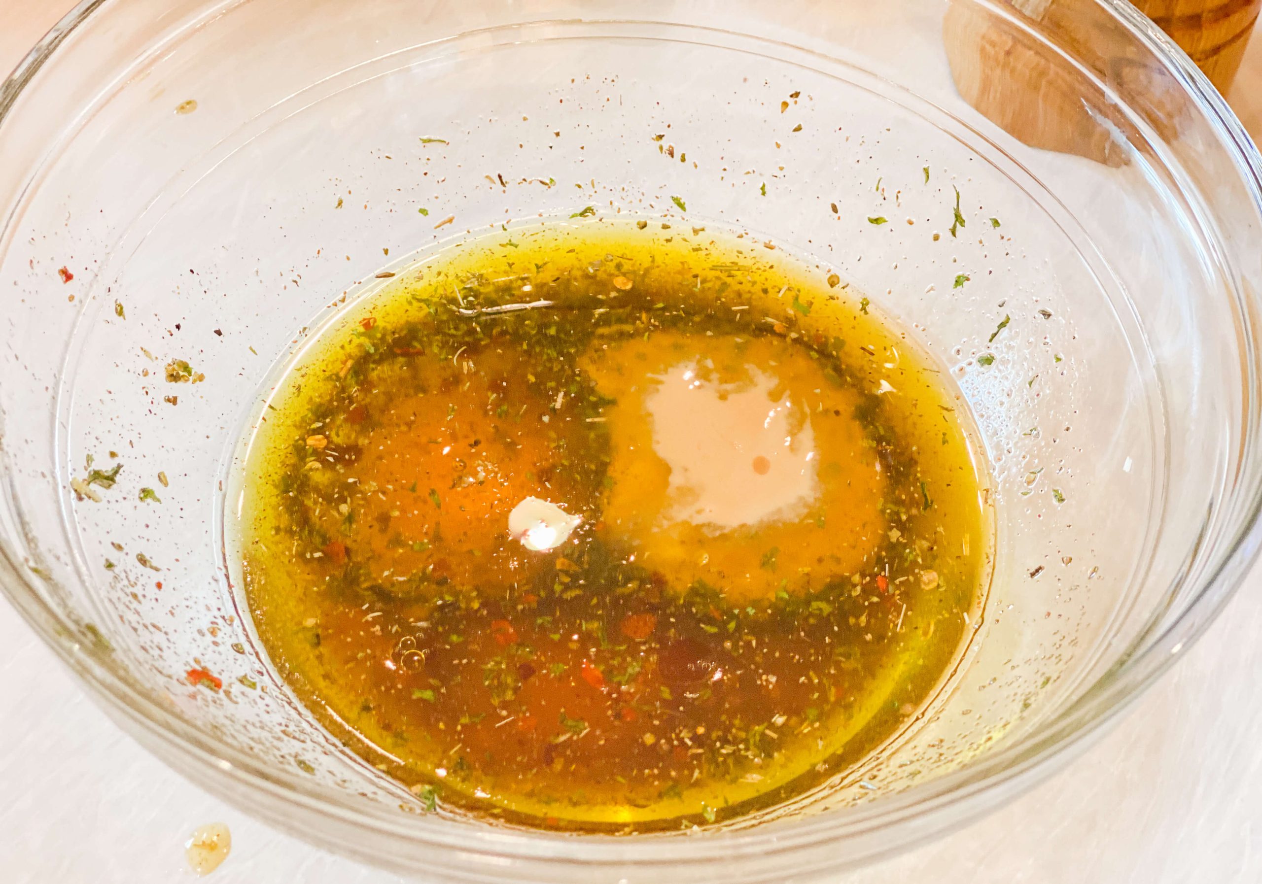olive oil mixture getting transformed into the vinaigrette 