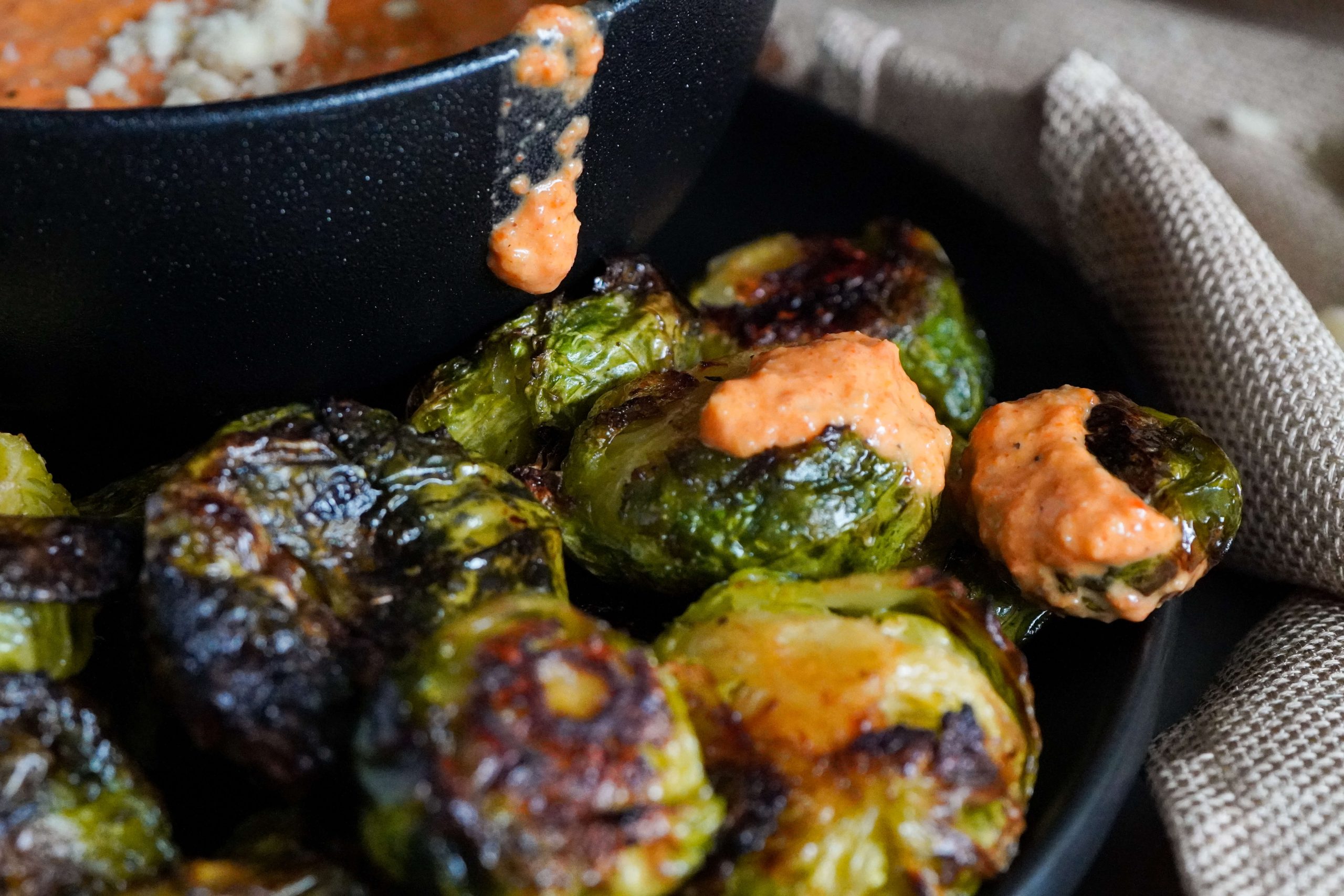 Brussel sprouts with the romesco sauce on them