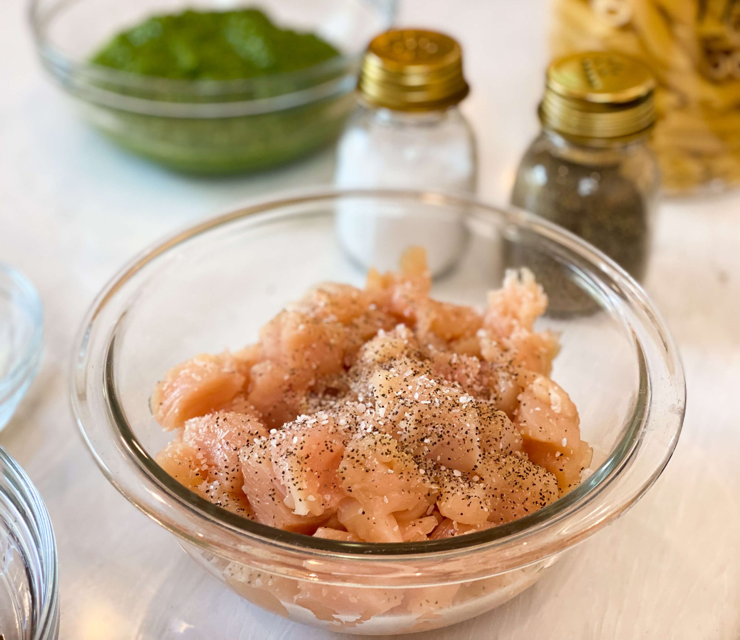 raw chicken bites seasoned with salt and pepper before getting cooked