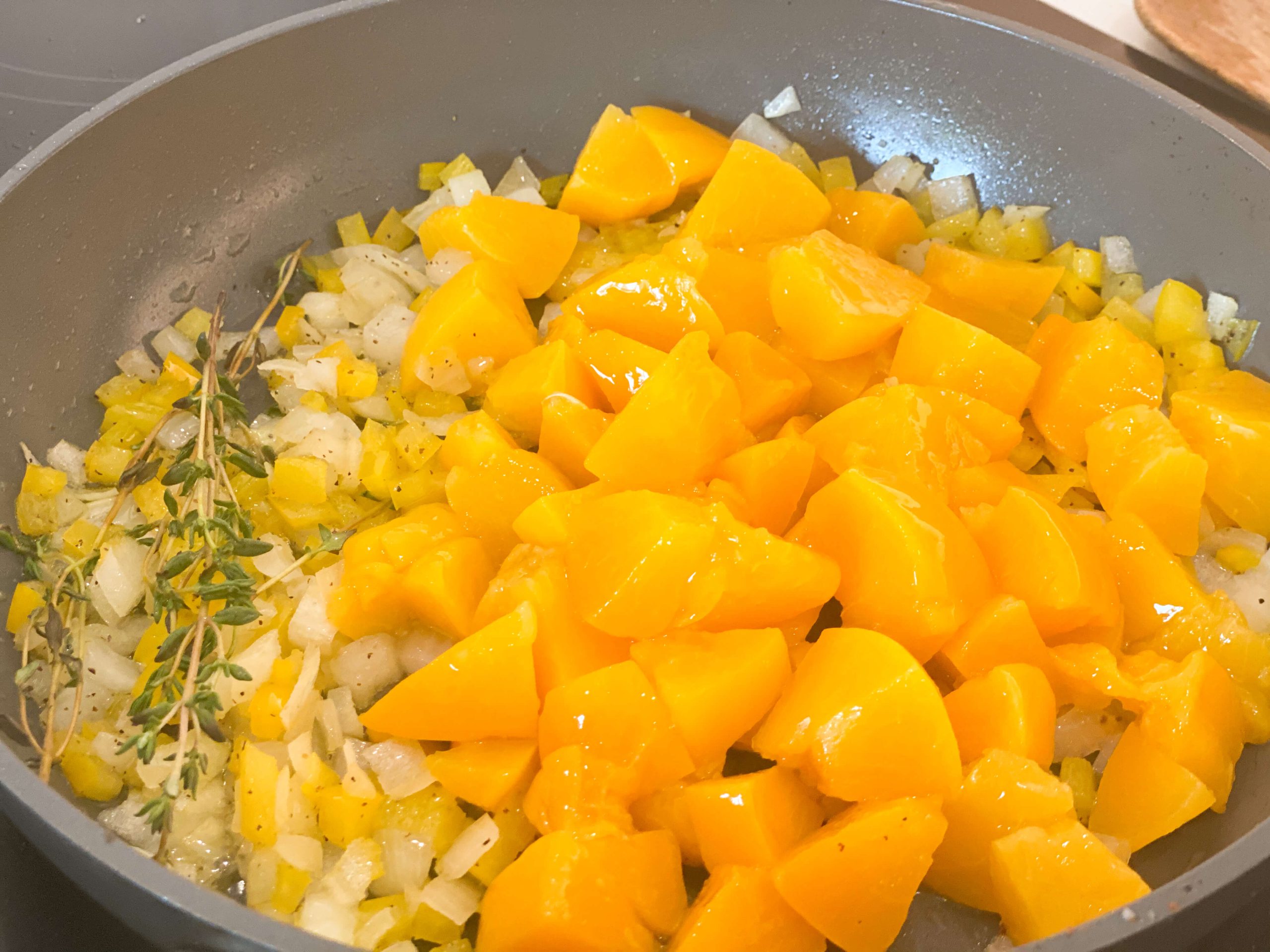 Peaches cooking with onion, peppers and thyme 