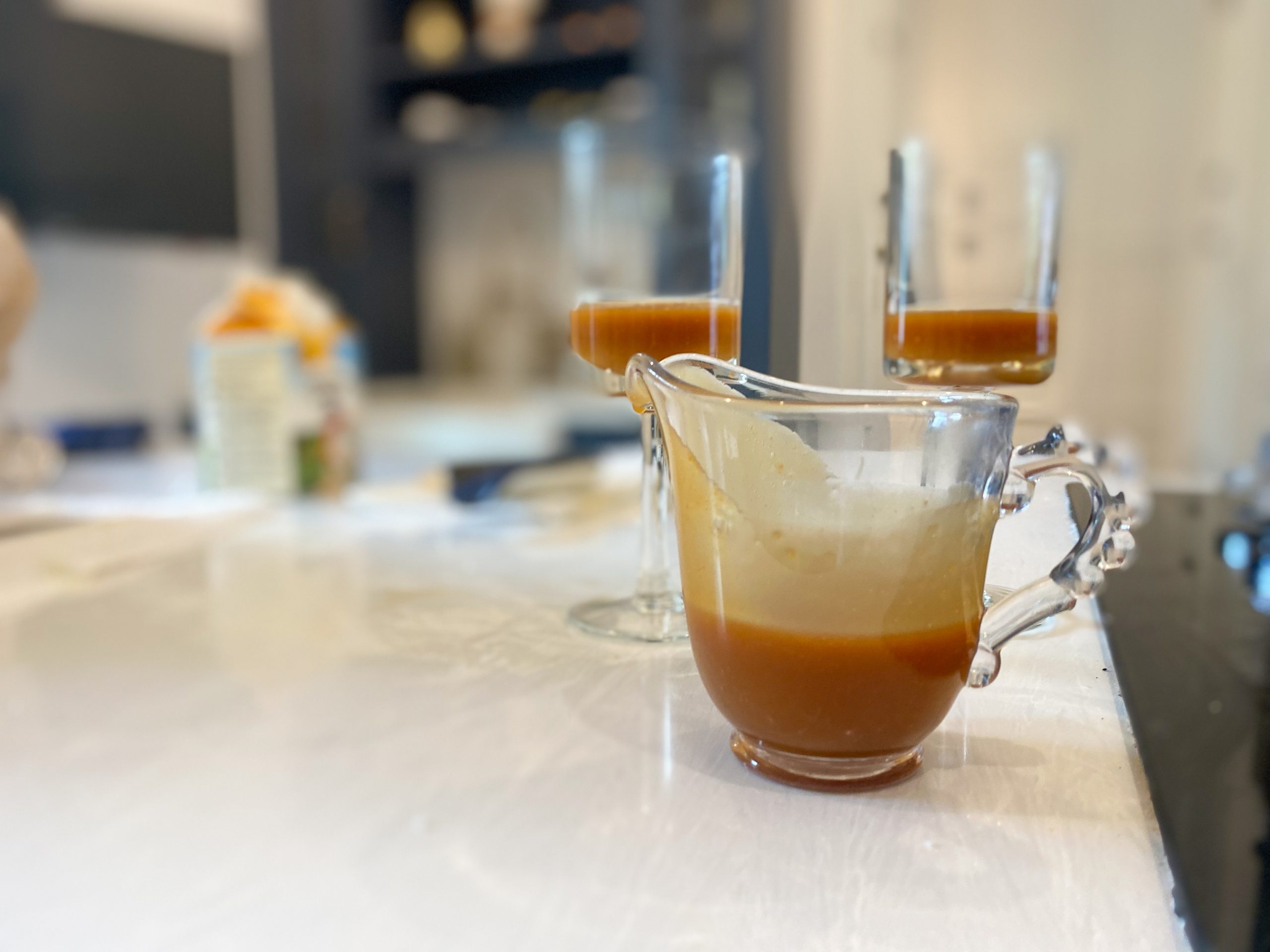 caramel in pouring cup and served in glasses