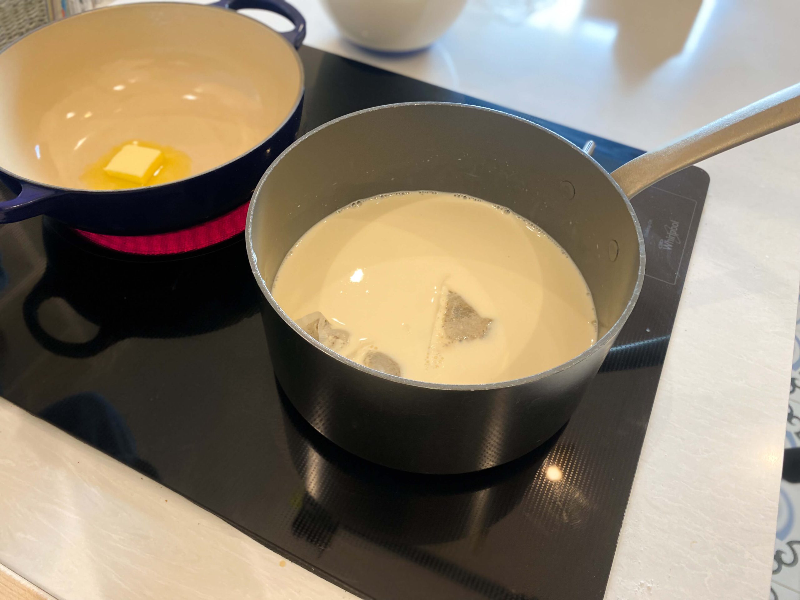 evaporated milk, 2% milk, sugar, chai tea bags heating in a pot