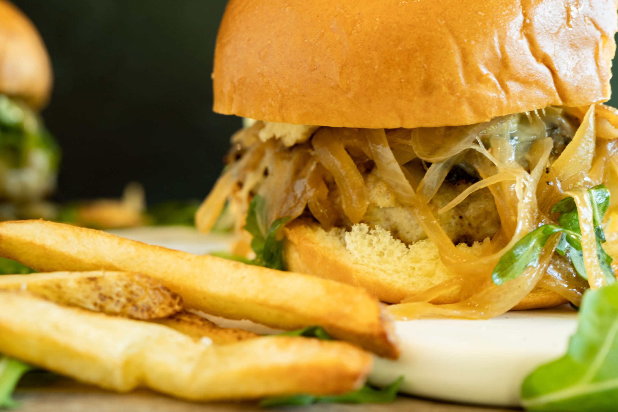 close up of the chicken burger with caramelized onions served
