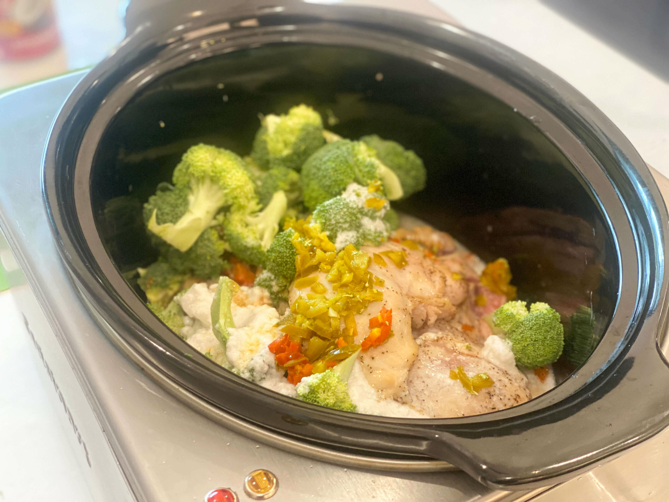 chicken and vegetables with coconut milk and seasonings in the slow cooker