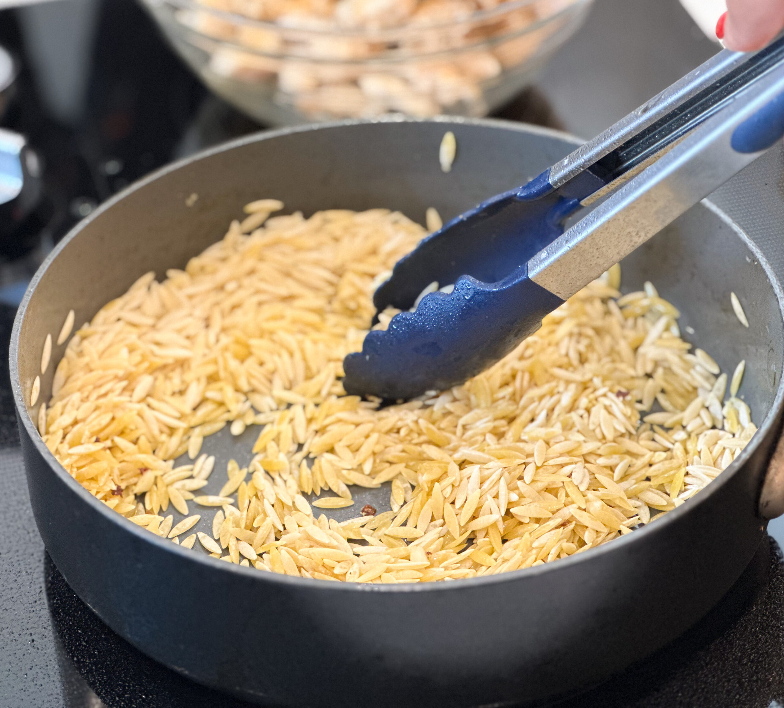 orzo tasting in pan with garlic