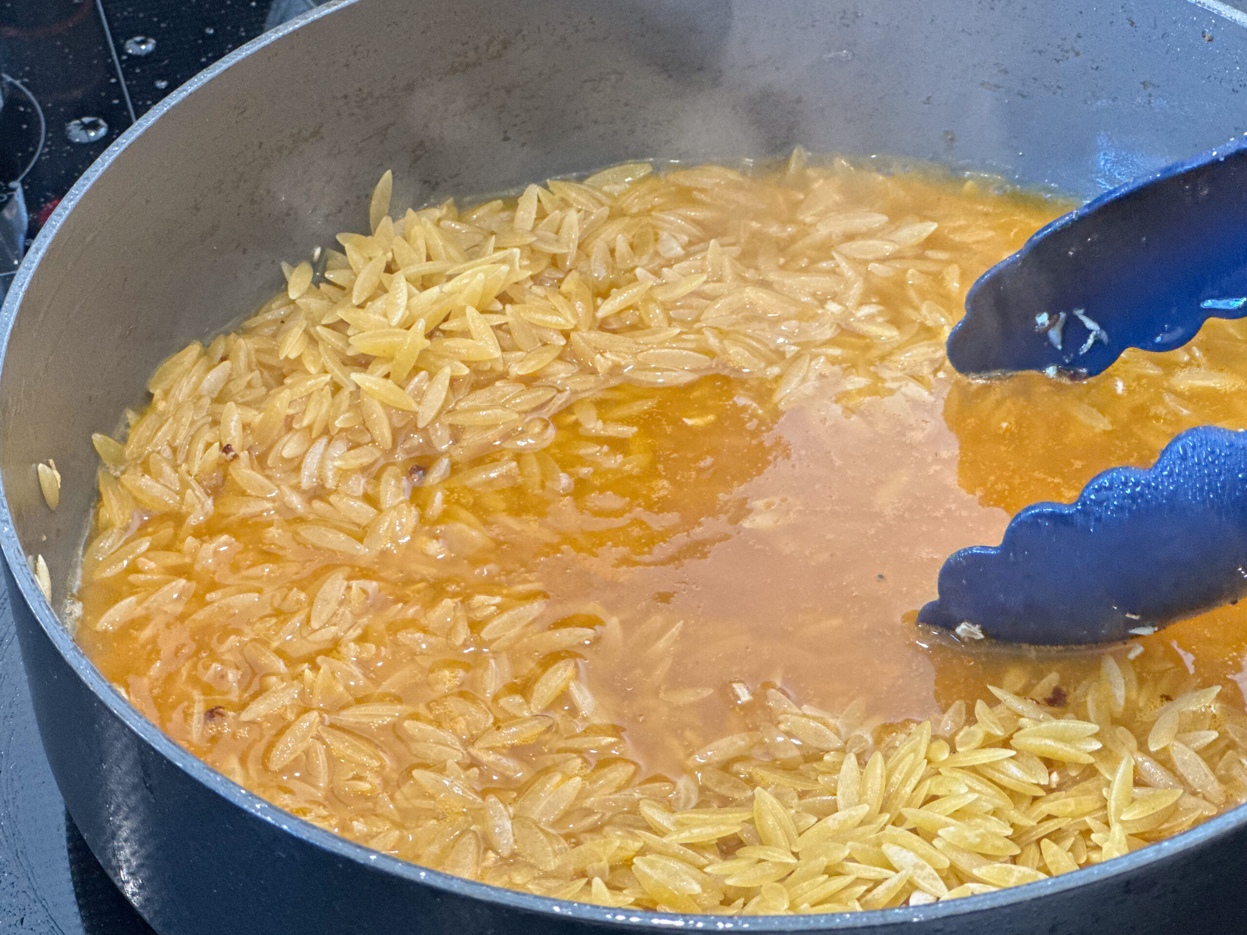 vegetable stock cooking with the orzo