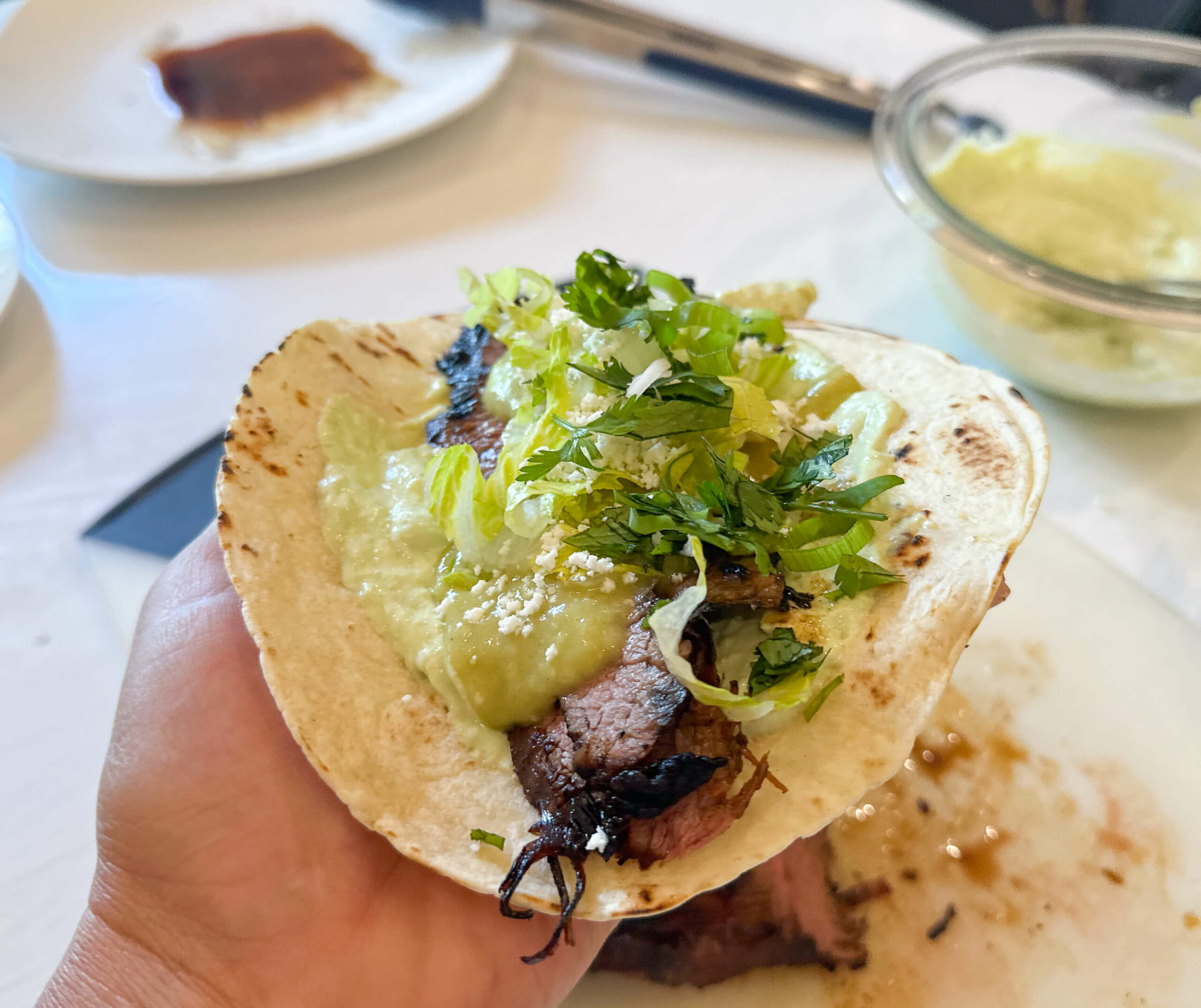 Flank Steak Taco assembled with toppings on top
