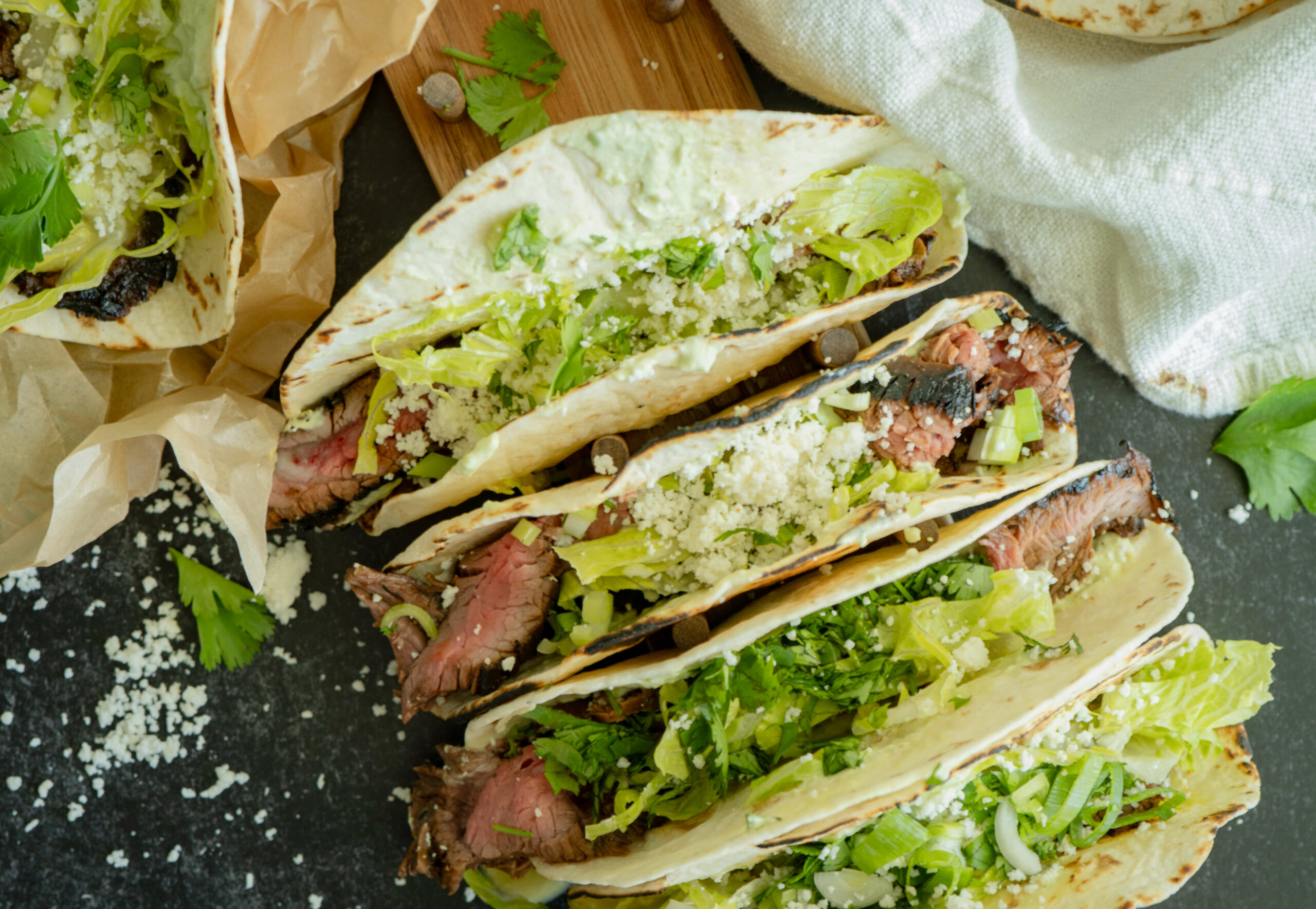 Flank Steak Tacos stacked and prepared with toppings
