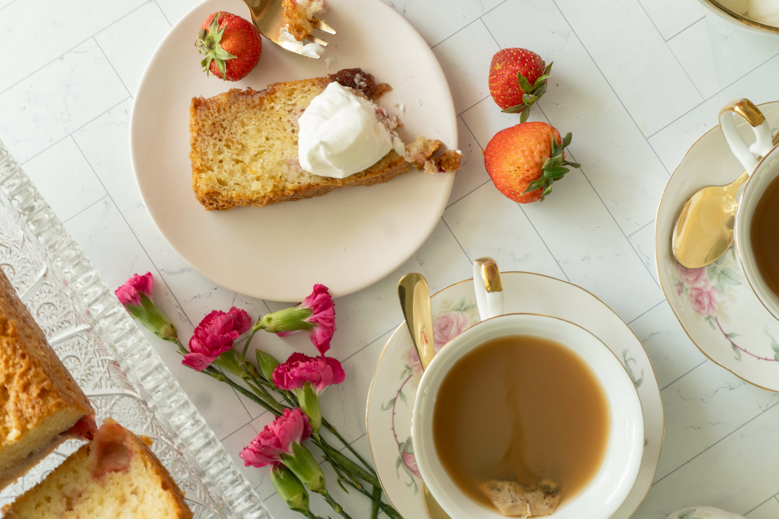 strawberry loaf cake served with whipped cream and fresh strawberries