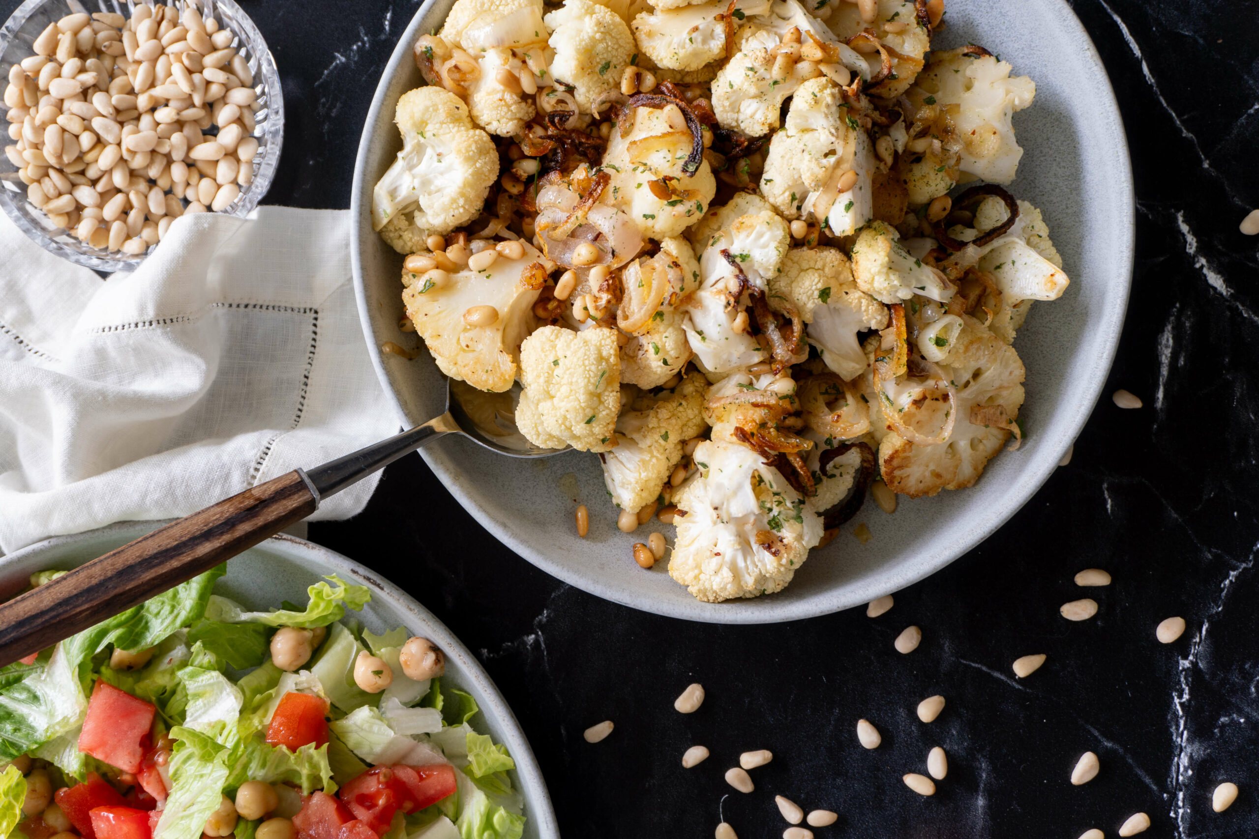 roasted cauliflower with shallots and pine nuts served and ready to eat. 